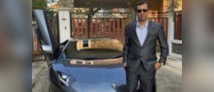 Alexandre Cazes standing in front of his Lamborghini